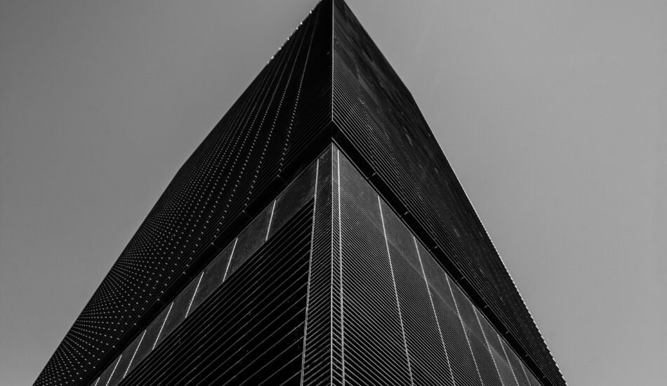 A low angle grayscale shot of a business building